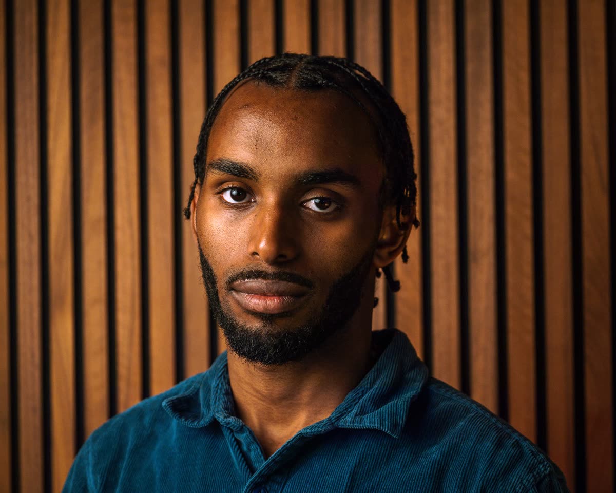 Portrait of Judah Daniels against wooden slats